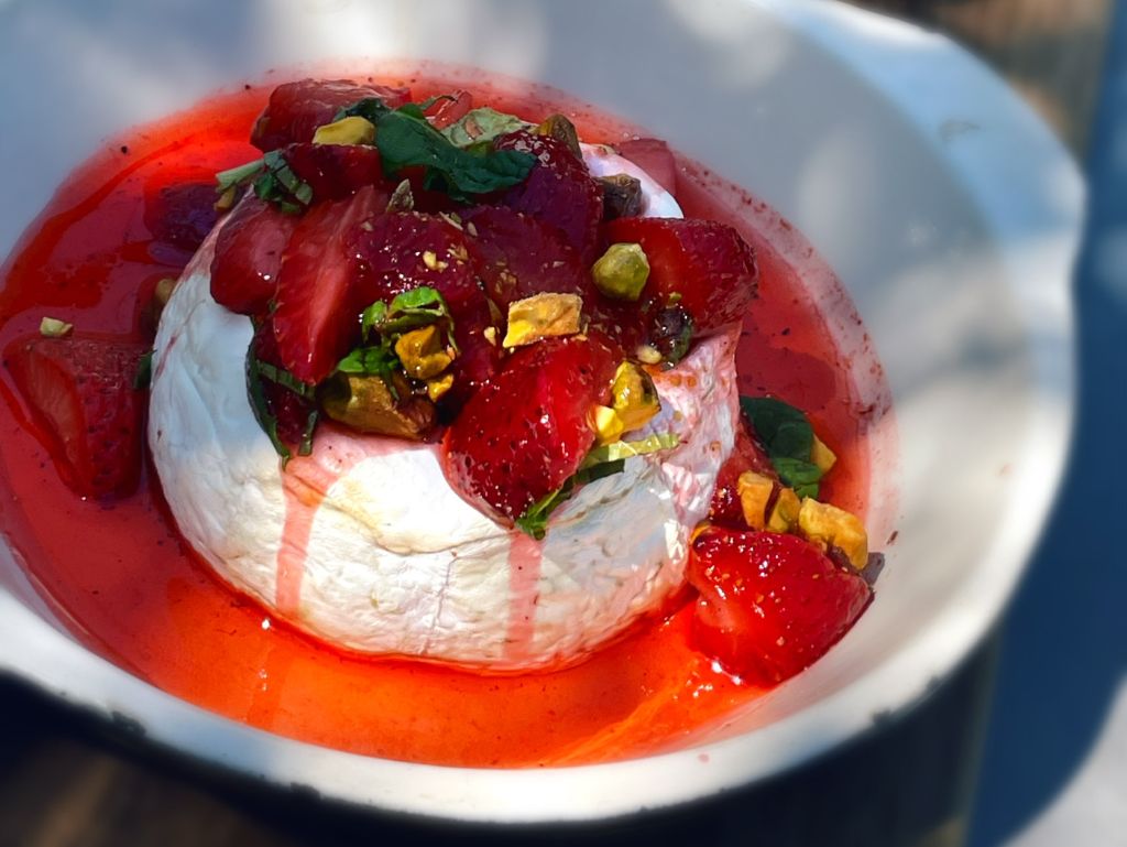 Baked brie with strawberry  vinegarette, a vibrant, must-try dish at Hops & Vine 